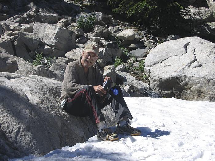 Phil Majerus back packing at Ross Lake, Wind River Range, Wyoming, in Ju...